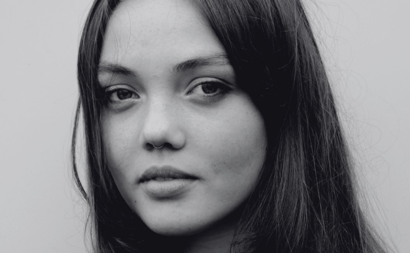 Black and white headshot of a young woman with long fair hair.