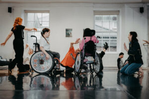 Image of a group of children and adults in a dance studio.