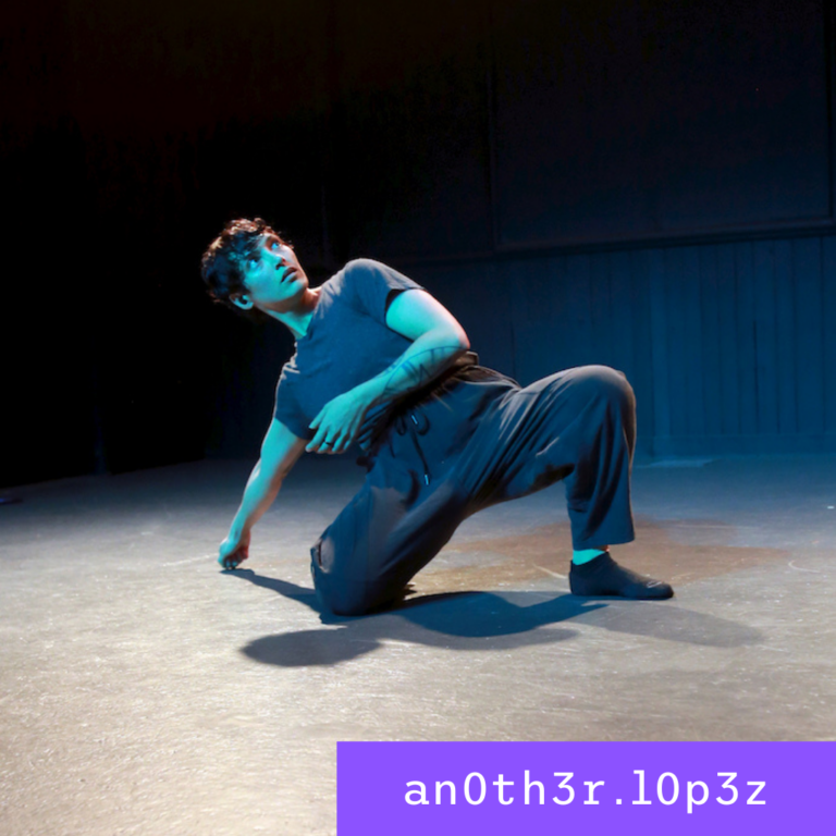 Picture of a dancer with one knee on the floor, leaning back on her right hand.
